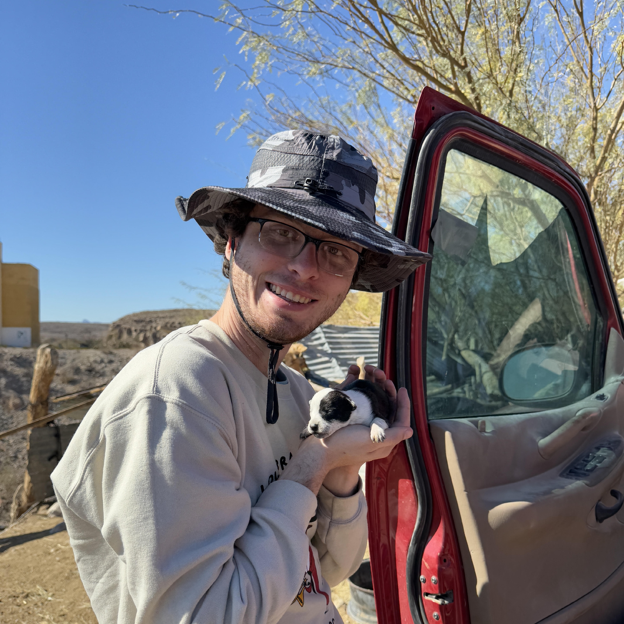 A picture of Nick holding a puppy.